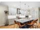 Well-lit kitchen featuring an island with seating, stainless steel appliances, and white cabinets at 581 Garfield St, Denver, CO 80206