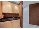 Compact kitchenette with modern cabinets, black countertop, and a sleek design aesthetic at 581 Garfield St, Denver, CO 80206