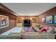 Cozy living room with brown walls, a large sectional sofa, built-in shelving, and colorful artwork at 581 Garfield St, Denver, CO 80206
