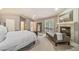 Spacious main bedroom featuring a cozy fireplace, seating and lots of natural light at 581 Garfield St, Denver, CO 80206