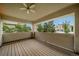 View of the beautiful wood-floored patio and outside neighborhood with green lush trees and blue sky at 581 Garfield St, Denver, CO 80206