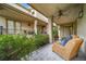 Spacious covered patio featuring patterned tile, comfortable wicker chairs, and garden views for outdoor relaxation at 581 Garfield St, Denver, CO 80206