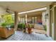 Charming covered patio with patterned tile flooring, comfortable seating, and access to the landscaped backyard at 581 Garfield St, Denver, CO 80206