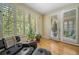 Bright sitting room featuring large windows, hardwood floors, and comfortable designer chair at 581 Garfield St, Denver, CO 80206