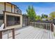 Back deck area featuring wooden patio and views of backyard at 4855 S Joplin St, Aurora, CO 80015