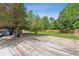 Backyard area featuring a wooden deck and various trees and greenery at 4855 S Joplin St, Aurora, CO 80015