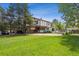 Backyard displaying lush lawn, mature trees, open patio and classic architecture for relaxing and enjoying the outdoors at 4855 S Joplin St, Aurora, CO 80015