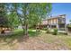 Expansive backyard featuring a large tree, deck and well-maintained lawn perfect for outdoor activities and entertaining at 4855 S Joplin St, Aurora, CO 80015