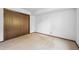 Empty bedroom with neutral carpeting and a closet featuring sliding doors at 4855 S Joplin St, Aurora, CO 80015