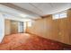 Basement bedroom featuring wood paneling, a closet, and carpeted floors at 4855 S Joplin St, Aurora, CO 80015