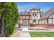 Charming exterior showcasing Tudor-style architecture, green lawn, and mature landscaping at 4855 S Joplin St, Aurora, CO 80015