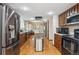 Well-equipped kitchen with stainless steel appliances and ample wood cabinets at 4855 S Joplin St, Aurora, CO 80015
