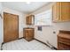 A laundry room features tile flooring, a sink, and a door at 4855 S Joplin St, Aurora, CO 80015