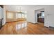 Bright living room featuring gleaming hardwood floors and an elegant chandelier fixture at 4855 S Joplin St, Aurora, CO 80015