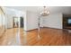 Spacious living room featuring abundant natural light, hardwood floors, and a stylish chandelier at 4855 S Joplin St, Aurora, CO 80015