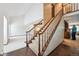 Elegant staircase showcasing wood banisters and bright, natural light from a vaulted ceiling at 4855 S Joplin St, Aurora, CO 80015