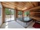 Sun room featuring a hot tub, wood paneled walls and ceilings, and sliding glass doors at 4855 S Joplin St, Aurora, CO 80015