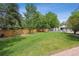 Backyard area boasting a vibrant lawn and a neat wooden fence, ideal for recreational activities and privacy at 4855 S Joplin St, Aurora, CO 80015