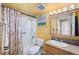 Updated bathroom with a shower/tub combo and wood vanity at 1301 Speer Blvd # 410, Denver, CO 80204
