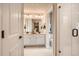 Bright bathroom featuring double sinks, white cabinets, and a walk-in shower at 12354 E 101St Dr, Commerce City, CO 80022