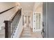 Inviting entryway features hardwood floors and a staircase with iron railings at 12354 E 101St Dr, Commerce City, CO 80022