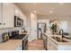 Bright kitchen features stainless steel appliances, white cabinets and light countertops at 12354 E 101St Dr, Commerce City, CO 80022