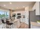 Modern kitchen with white cabinets, stainless steel appliances, and a center island with seating at 12354 E 101St Dr, Commerce City, CO 80022