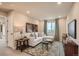 Inviting living room featuring a comfortable sectional sofa and stylish decor at 12354 E 101St Dr, Commerce City, CO 80022