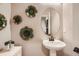 Stylish powder room features elegant mirror and decorative wall accents at 12354 E 101St Dr, Commerce City, CO 80022