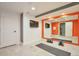Finished basement gym area with workout equipment, full wall mirror and television at 15592 W Wesley Ave, Lakewood, CO 80228