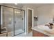 Modern bathroom featuring a glass shower with decorative tile and double vanity with granite countertop at 15592 W Wesley Ave, Lakewood, CO 80228