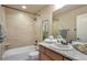 Well-lit bathroom featuring a tub-shower, granite countertop, and modern fixtures at 15592 W Wesley Ave, Lakewood, CO 80228