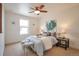 Inviting bedroom with a ceiling fan, a comfy bed, and bright natural light from the window at 15592 W Wesley Ave, Lakewood, CO 80228