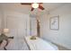 Bright bedroom featuring neutral tones, a ceiling fan, and a closet with paneled doors at 15592 W Wesley Ave, Lakewood, CO 80228