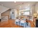 Open-concept dining room with hardwood floors and a modern chandelier next to the kitchen at 15592 W Wesley Ave, Lakewood, CO 80228