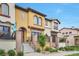 Eye-catching townhome featuring a stucco exterior, front patios, and well-manicured landscaping at 15592 W Wesley Ave, Lakewood, CO 80228