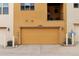 Attached garage with yellow door and a balcony above, complemented by tidy landscaping at 15592 W Wesley Ave, Lakewood, CO 80228