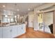 Well-lit kitchen island with white cabinets and opening to the dining room and living area at 15592 W Wesley Ave, Lakewood, CO 80228
