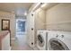 Convenient laundry area with side-by-side washer and dryer and ample storage space at 15592 W Wesley Ave, Lakewood, CO 80228