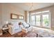 Bright living room featuring a comfortable sofa, chandelier and access to a private balcony at 15592 W Wesley Ave, Lakewood, CO 80228