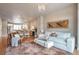 Inviting living room with hardwood floors, a decorative chandelier and opening to the dining and kitchen at 15592 W Wesley Ave, Lakewood, CO 80228
