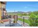 Relaxing patio with seating and views of green space and mountain in the background at 15592 W Wesley Ave, Lakewood, CO 80228