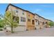 View of the townhome exteriors with attached garages and well maintained landscaping at 15592 W Wesley Ave, Lakewood, CO 80228