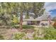 Lush backyard with mature trees, patio, fire pit, and ample green space for outdoor activities and relaxation at 6267 S Albion Ct, Centennial, CO 80121