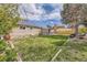 Large grassy backyard with a fire pit area and patio for outdoor relaxation and activities at 6267 S Albion Ct, Centennial, CO 80121