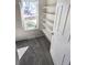 Carpeted walk-in closet featuring built-in shelving and natural light from a window at 6267 S Albion Ct, Centennial, CO 80121