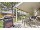 Covered patio offers the perfect spot for outdoor grilling with a spacious table set and a well-maintained backyard at 6267 S Albion Ct, Centennial, CO 80121