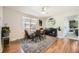 Elegant dining room featuring stylish rug, wood floors, modern decor, and plenty of natural light at 6267 S Albion Ct, Centennial, CO 80121