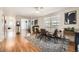 Bright dining room with wood floors, modern furnishings, and a large window with neighborhood views at 6267 S Albion Ct, Centennial, CO 80121