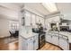 Efficient kitchen featuring stainless steel appliances, white cabinets, and open layout to the dining area at 6267 S Albion Ct, Centennial, CO 80121